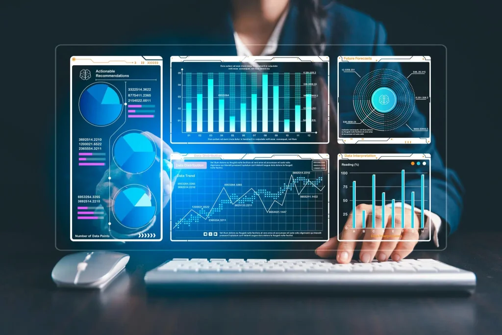 Person typing at a keyboard in front of holographic analytics charts